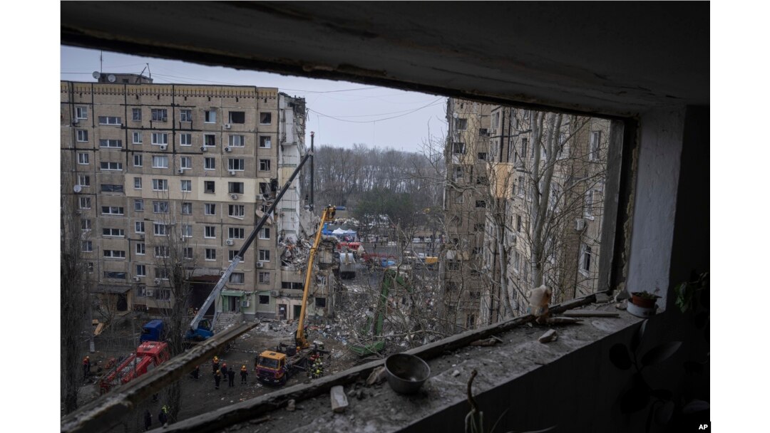 FILE - Rescue workers clear the rubble from an apartment building that was destroyed in a Russian rocket attack at a residential neighborhood in the southeastern city of Dnipro, Ukraine, Jan. 16, 2023.