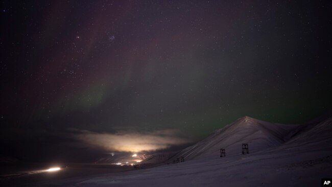 An aurora is pictured during a long exposure in Longyearbyen, Norway, Jan. 11, 2023.