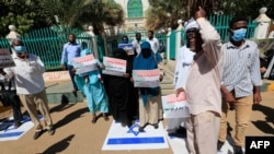 FILE - Sudanese demonstrators chant slogans as they step on Israeli flags during a rally against their country's signing of a deal normalizing relations with the Jewish state, in Sudan's capital Khartoum, Jan. 17, 2021.