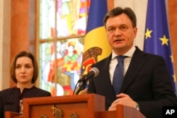 Moldovan Prime Minister designate Dorin Recean speaks after being appointed by President Maia Sandu, left, to form a new government in Chisinau, Moldova, Feb 10, 2023.