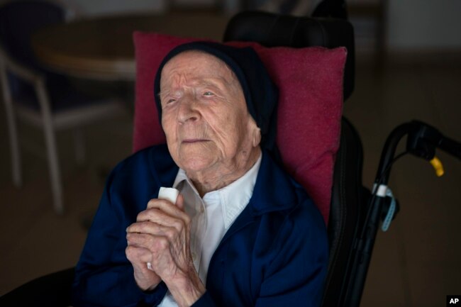 FILE - Sister Andre poses for a portrait at the Sainte Catherine Laboure care home in Toulon, southern France, Wednesday, April 27, 2022. (AP Photo/Daniel Cole)