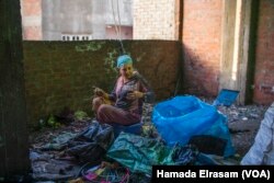 Omu Mina, a 42-year-old mother of four, says, “My husband is sick and unable to work long hours anymore. Now I sort trash after my work as a rug weaver to pay for our children’s schooling.”