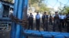 FILE - Police stand guard at the Judicial Assistance Directorate holding center as they face demonstrators, on the other side of the fence, protesting the arrests of anti-government protesters in Managua, Nicaragua, April 25, 2018.