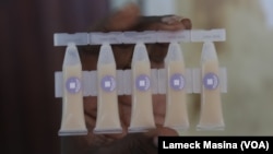 A medical worker holds the oral cholera vaccine that is now in short supply in Malawi.