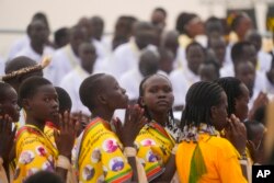 People pray as Pope Francis celebrates Mass at the John Garang Mausoleum in Juba, South Sudan, Feb. 5, 2023.