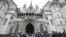 FILE - Media wait outside the High Court in London, on March 18, 2021. 