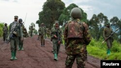 FILE - Congolese M23 rebels withdraw from an area in Kibumba, near Goma, North Kivu province of the Democratic Republic of Congo, Dec. 23, 2022.