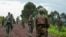 FILE - Congolese M23 rebels are seen withdrawing from an area in Kibumba, near Goma, North Kivu province of the Democratic Republic of Congo, Dec. 23, 2022. Congolese President Felix Tshisekedi said Jan. 17, 2023, that the group is faking a pullback of its forces. 