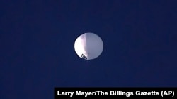 FILE: A high altitude balloon floats over Billings, Mont., on Wednesday, Feb. 1, 2023. The U.S. is tracking a suspected Chinese surveillance balloon that has been spotted over U.S. airspace for a couple days, officials said Thursday, Feb. 2, 2023. 