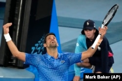 Novak Djokovic of Serbia reacts after defeating Stefanos Tsitsipas of Greece in the men's singles final at the Australian Open tennis championship in Melbourne, Australia, Sunday, Jan. 29, 2023. (AP Photo/Mark Baker)