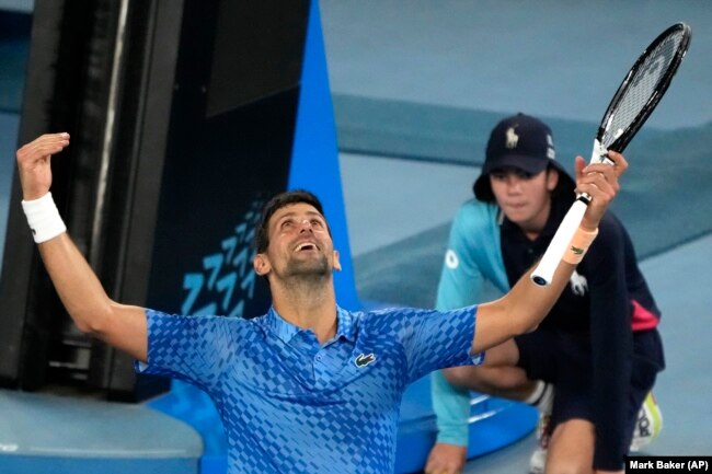 Novak Djokovic of Serbia reacts after defeating Stefanos Tsitsipas of Greece in the men's singles final at the Australian Open tennis championship in Melbourne, Australia, Sunday, Jan. 29, 2023. (AP Photo/Mark Baker)