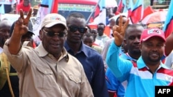 Freeman Mbowe (L), Chairman Tanzania's main opposition party Chadema, flashes a victory sign during party's first political rally after an imposed ban in 2016 was lifted, at Furahisha Grounds in Mwanza, on January 21, 2023. 