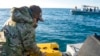 Sailors assigned to an ordnance disposal group prepare an underwater vehicle to search for debris from a Chinese high-altitude balloon off the coast of Myrtle Beach, S.C., Feb. 7, 2023. (Ryan Seelbach/U.S. Navy via AP)