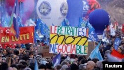 Protesters rally against the French government's pension reform plan, in Paris, Feb. 7, 2023.