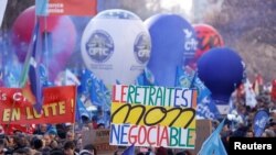 Protesters rally against the French government's pension reform plan, in Paris, Feb. 7, 2023.