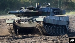 FILE - A Leopard 2 tank is pictured during a demonstration event held for the media by the German Bundeswehr in Munster near Hannover, Germany, Wednesday, Sept. 28, 2011. (AP Photo/Michael Sohn, File)