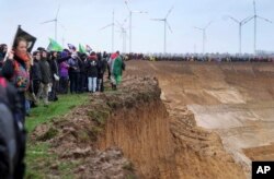 Aksi protes aktivis lingkungan di pertambangan terbuka Garzweiler dekat desa Luetzerath di Erkelenz, Jerman, Sabtu, 14 Januari 2023. (AP/Michael Probst)