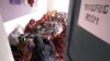 FILE - Afghan women work in a tailoring room of an aid center created by a French NGO, in Afghanistan, Oct. 9, 2001.