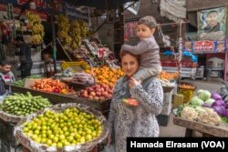 Omu Pola, a 30-year-old mother of four, says, “My children are young and fussy, and I’m struggling to buy them the food they really like: chicken. Whenever I try to feed them just vegetables or rice, they refuse.”