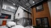 Simulated snow covers a car and the walls of one of two houses built to develop future heating solutions, at Energy House 2.0 in Salford, UK, Jan. 24, 2023.