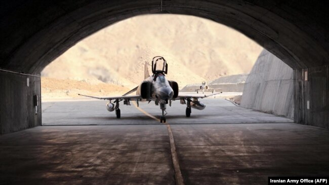 A handout picture provided by the Iranian Army Office on Feb. 7, 2023, shows a fighter jet during the unveiling of Iran's first underground military air base in an undisclosed location.