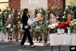 FILE - Vice President Kamala Harris visits a memorial set up outside Star Dance Studio in Monterey Park, California, Jan. 25, 2023.