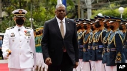 Menteri Pertahanan A.S. Lloyd Austin (kedua dari kiri) berjalan melewati pasukan kehormatan setibanya di Departemen Pertahanan Nasional di kamp militer Camp Aguinaldo, Quezon City, Metro Manila, Filipina, Kamis 2 Februari 2023. (Rolex Dela Pena/Pool Photo via AP)