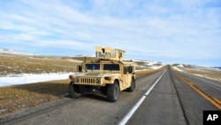 A U.S. Air Force security vehicle is seen Feb 7, 2023, near Harlowton, Mont. State and federal lawmakers are weighing further curbs on foreign ownership of U.S. farmland following last week’s cross-country trip by a Chinese balloon. (Matthew Brown/AP)