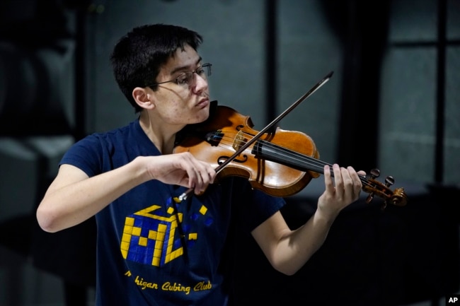 University of Michigan student Stanley Chapel performs one of Johann Sebastian Bach's violin sonatas from memory, Wednesday, Nov. 23, 2022, in Ann Arbor, Mich. (AP Photo/Carlos Osorio)