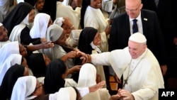 FILE: Pope Francis' shakes hands to nuns at the end of the morning prayer at the Monastery of the Discalced Carmelites in Antananarivo, Madagascar. Taken Sept. 7, 2019