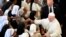 FILE: Pope Francis' shakes hands to nuns at the end of the morning prayer at the Monastery of the Discalced Carmelites in Antananarivo, Madagascar. Taken Sept. 7, 2019