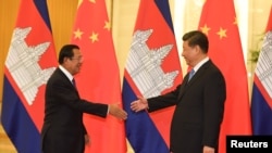 FILE - Cambodia’s Prime Minister Hun Sen shakes hands with China's President Xi Jinping before their meeting at the Great Hall of the People in Beijing, Apr. 29, 2019. (Madoka Ikegami/Pool via Reuters)