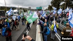 Israeli military reservists block the main highway from Jerusalem to Tel Aviv as they demonstrate against proposed judicial reforms by Israel's new right-wing government in Shoresh near Jerusalem, Feb. 9, 2023. 
