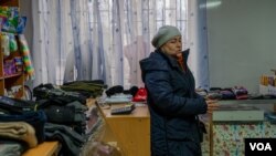 Lubov Bilous sells military accessories, flashlights and radios in her store, which once sold only children's toys, in Chasiv Yar, Ukraine, Jan. 22, 2023 (Yan Boechat/VOA)