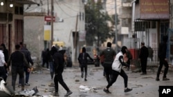Palestinians clash with Israeli forces raiding Aqbat Jabr camp, southwest of the city of Jericho on Feb. 4, 2023, during a search for the Palestinian suspects behind a shooting attack last week.