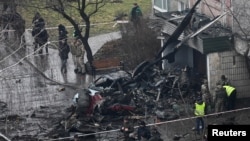 The site of a helicopter crash in the town of Brovary, outside Kyiv, Ukraine, Jan. 18, 2023.