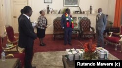 Justice Priscilla Chigumba of ZEC handing over the Revised Preliminary Delimitation Report to President Emmerson Mnangagwa
