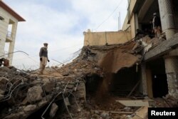 A man stands amid a damaged structure, days after a suicide blast in a mosque in Peshawar, Pakistan, Feb. 1, 2023.