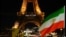 An Iranian national flag is seen as the Eiffel Tower is lit up with the slogan "Women, Life, Liberty" in support of Iranians protesting against their government, in Paris, Jan. 16, 2023. 