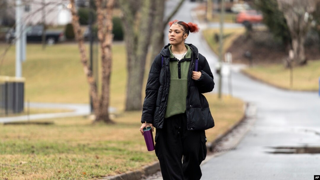 FILE - Kailani Taylor-Cribb walks through her neighborhood in Asheville, N.C., Jan. 31, 2023. Kailani hasn’t taken a single class in what used to be her high school since the height of the coronavirus pandemic.