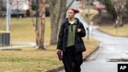 FILE - Kailani Taylor-Cribb walks through her neighborhood in Asheville, N.C., Jan. 31, 2023. Kailani hasn’t taken a single class in what used to be her high school since the height of the coronavirus pandemic.