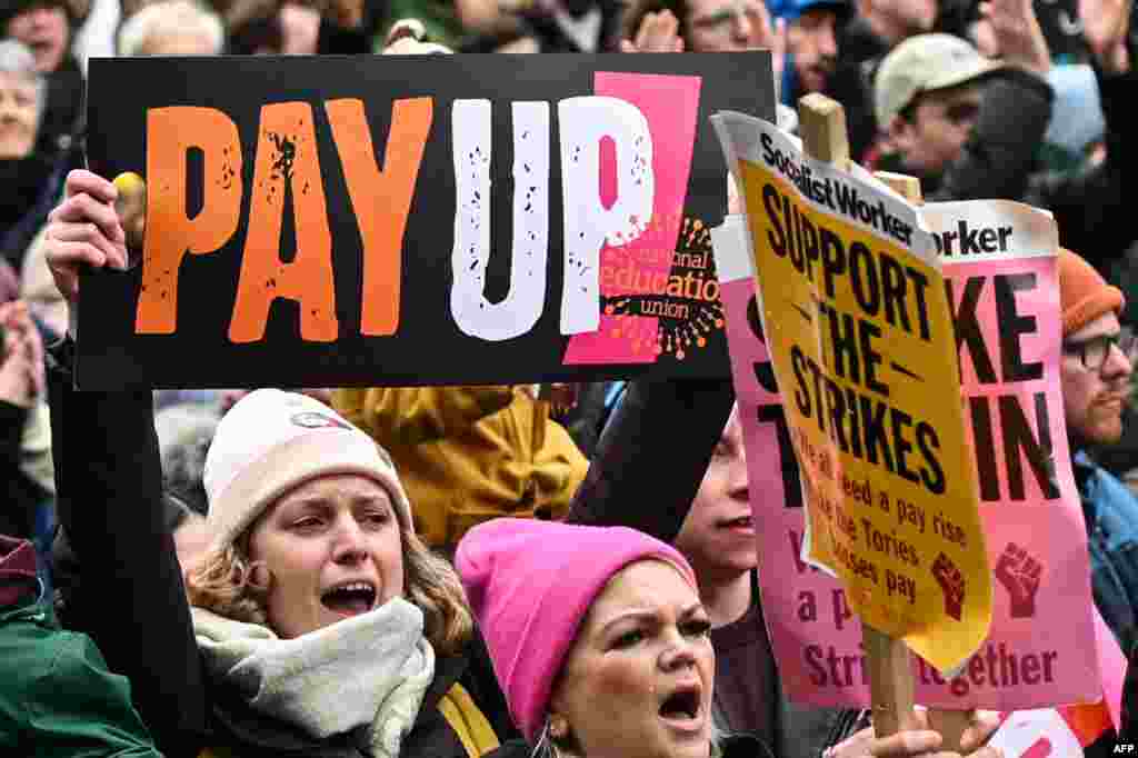 Teachers hold signs as they shout expressions during a protest organized by NEU and other affiliated trade unions at Saint Peter&#39;s Square in Manchester, as part of a national strike day.&nbsp;Children missed school and commuters faced severe disruption in Britain as up to half a million workers staged walkouts calling for higher wages in the largest such strikes in more than 10 years.