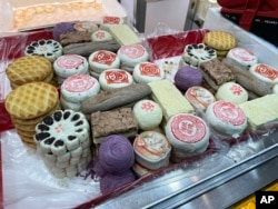 Two new year gift boxes of traditional pastries appear at a bakery in Beijing, China on Jan. 14, 2023. (AP Photo/Caroline Chen)