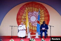 Pope Francis and Democratic Republic of Congo's President Felix Tshisekedi sit on the stage during a meeting in Kinshasa, Democratic Republic of Congo, Jan. 31, 2023.