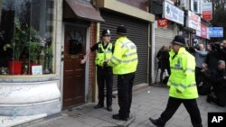 Police outside a property in Birmingham, England, March 23, 2017, following an attack Wednesday in London.