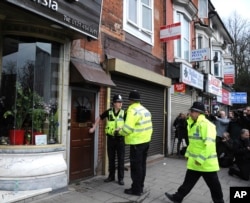 Police outside a property in Birmingham, England, March 23, 2017, following an attack on Wednesday in London.