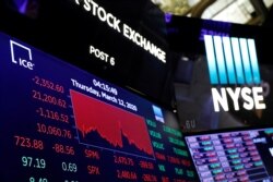 A price screen display is seen above the floor of the New York Stock Exchange after the close of trading in New York, March 12, 2020.