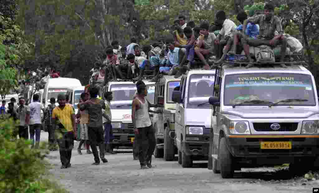 Indian villagers leave their homes following ethnic clashes in Kokrajhar, India, July 24, 2012.
