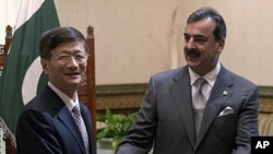 CChinese Public Security Minister Meng Jianzhu, left, shakes hands with Pakistan's Prime Minister Yusuf Raza Gilani in Islamabad, Pakistan. China's top security official is visiting Pakistan for talks focusing on increased cooperation against Chinese mili