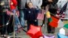 A young girl looks at a memorial to the victims of the Boston Marathon bombings on Boylston Street near the scene of the blasts in Boston, Massachusetts, Apr. 20, 2013. 